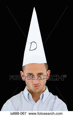 Stock Photo - Man wearing a dunce cap. Fotosearch