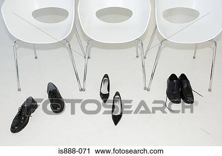 Stock Image - Shoes and chairs in a row. Fotosearch