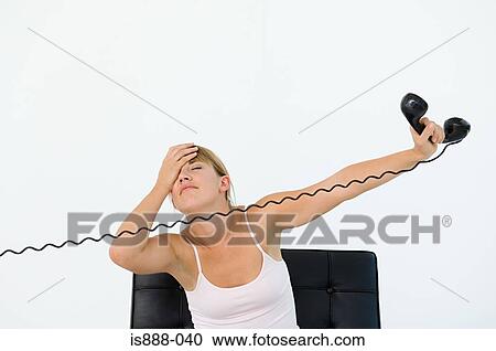 Stock Image - Stressed woman holding phone. Fotosearch