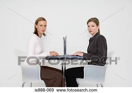 Stock Photo - Two women using laptops. Fotosearch