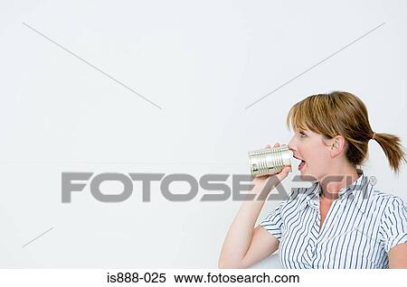 Woman using tin can telephone View Large Photo Image Stock Photography - Woman using tin can telephone. Fotosearch