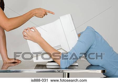 Stock Image - Woman with head inside computer monitor. Fotosearch