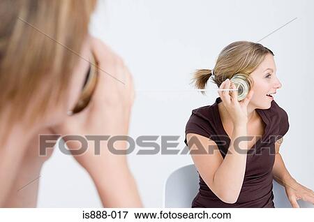Stock Photo - Women using tin can telephone. Fotosearch