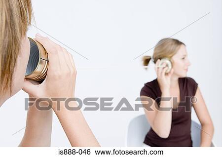 Stock Photograph - Women using tin can telephone. Fotosearch