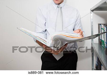 Businessman holding file View Large Photo Image Stock Image - Businessman holding file. Fotosearch