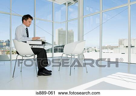 Businessman looking at files View Large Photo Image Stock Image - Businessman looking at files. Fotosearch