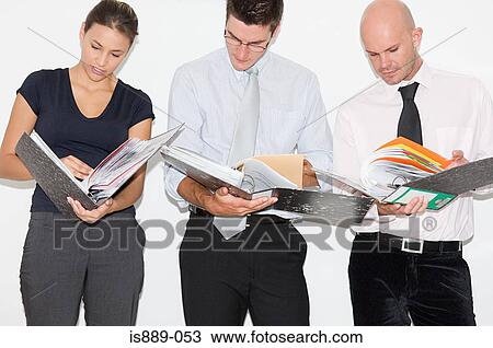 Stock Image - Businesspeople looking at files. Fotosearch