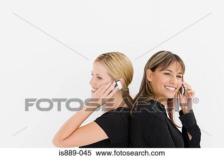 Stock Photography - Businesswomen using cell phones. Fotosearch