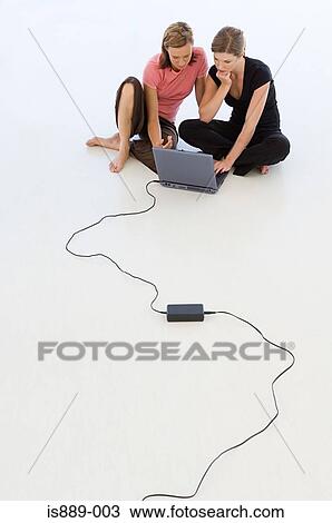 Stock Image - Colleagues working on laptop. Fotosearch