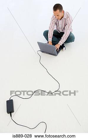 Stock Photo - Man working on laptop. Fotosearch