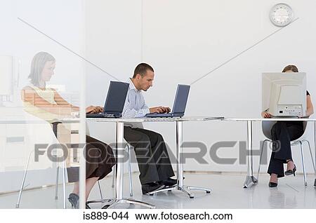 Office workers working on computers View Large Photo Image Picture - Office workers working on computers. Fotosearch