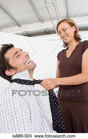 Woman fastening mans tie View Large Photo Image Picture - Woman fastening mans tie. Fotosearch