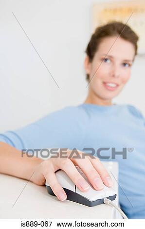 Stock Photo - Woman using computer mouse. Fotosearch