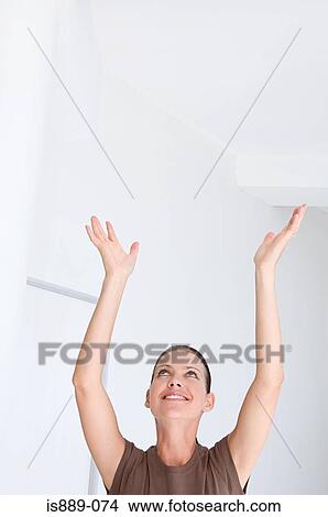 Picture - Woman with arms raised. Fotosearch