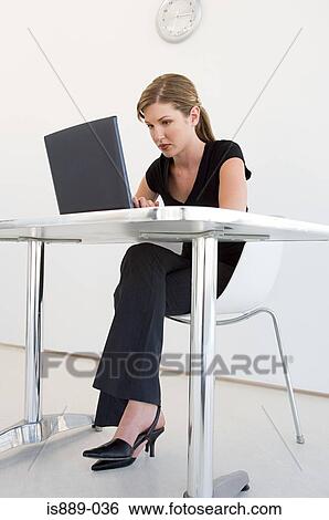 Stock Photograph - Woman working on laptop. Fotosearch