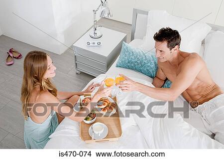 Couple having breakfast in bed View Large Photo Image Picture - Couple having breakfast in bed. Fotosearch