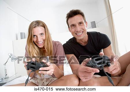 Stock Photography - Couple playing computer game. Fotosearch