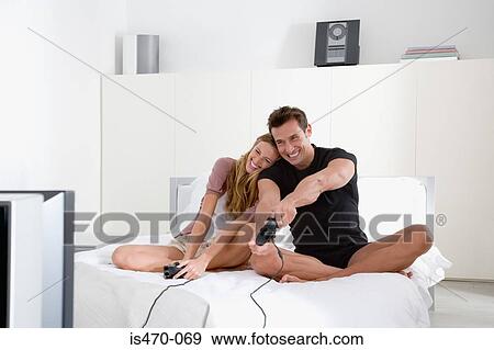 Couple playing video game View Large Photo Image Stock Photo - Couple playing video game. Fotosearch