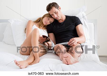 Couple reading a magazine View Large Photo Image Stock Image - Couple reading a magazine. Fotosearch