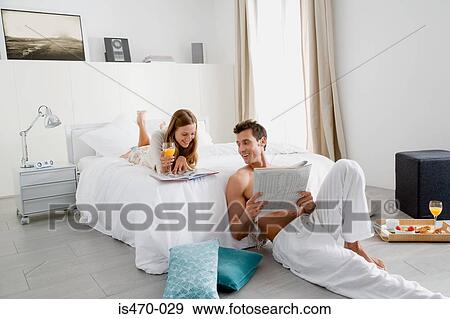 Stock Photo - Couple reading in bedroom. Fotosearch