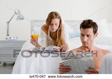 Couple reading in bedroom View Large Photo Image Stock Photo - Couple reading in bedroom. Fotosearch