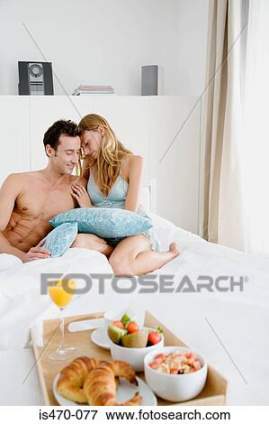 Intimate couple with breakfast in bed View Large Photo Image Stock Photo - Intimate couple with breakfast in bed. Fotosearch