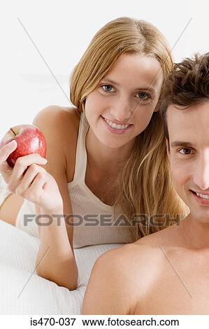 Man and woman with apple View Large Photo Image Stock Photo - Man and woman with apple. Fotosearch