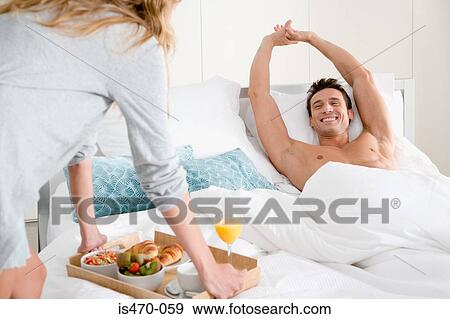 Man getting breakfast in bed View Large Photo Image Stock Photo - Man getting breakfast in bed. Fotosearch