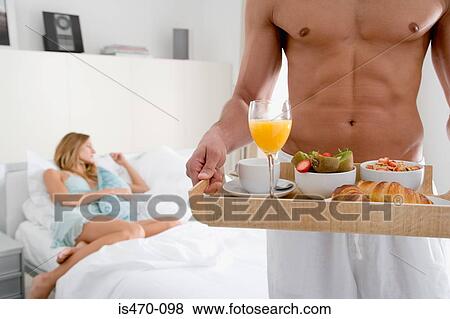 Man with breakfast tray View Large Photo Image Stock Photo - Man with breakfast tray. Fotosearch