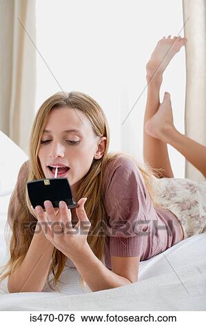Woman applying lipgloss View Large Photo Image Stock Photograph - Woman applying lipgloss. Fotosearch