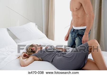 Woman lying on bed looking up at man View Large Photo Image Stock Photo - Woman lying on bed looking up at man. Fotosearch