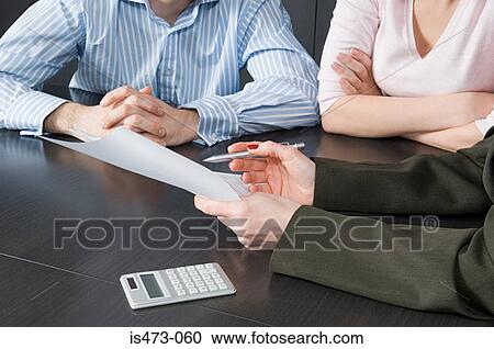 Stock Image - Bank manager helping couple. Fotosearch
