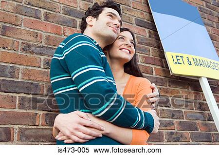 Couple hugging outside house View Large Photo Image Stock Photography - Couple hugging outside house. Fotosearch