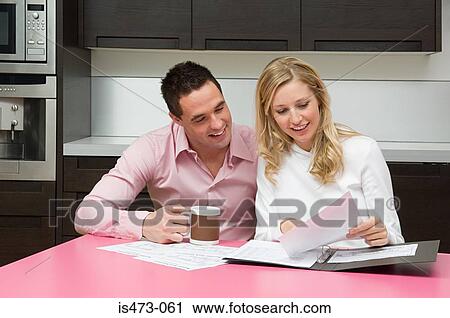 Couple looking at bank statements View Large Photo Image Stock Image - Couple looking at bank statements. Fotosearch