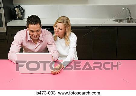 Stock Image - Couple using internet. Fotosearch