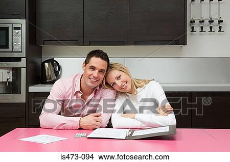 Couple with bank statements View Large Photo Image Picture - Couple with bank statements. Fotosearch