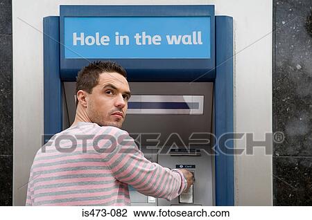 Man looking over shoulder at cash machine View Large Photo Image Stock Image - Man looking over shoulder at cash machine. Fotosearch