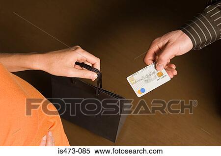 Stock Photography - Man passing credit card. Fotosearch