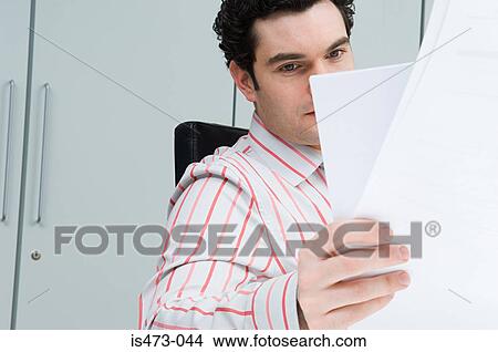 Picture - Man reading paperwork. Fotosearch