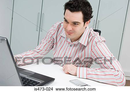 Picture - Man using laptop. Fotosearch
