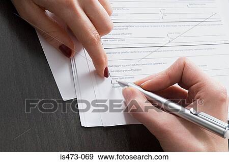 Stock Photo - Person signing document. Fotosearch