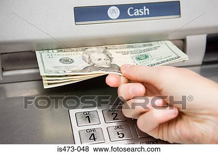 Person withdrawing cash View Large Photo Image Stock Photo - Person withdrawing cash. Fotosearch