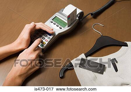 Woman entering pin into credit card reader View Large Photo Image Stock Photo - Woman entering pin into credit card reader. Fotosearch