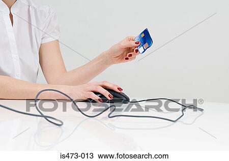 Stock Image - Woman holding credit card. Fotosearch
