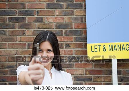 Woman holding key View Large Photo Image Stock Photography - Woman holding key. Fotosearch