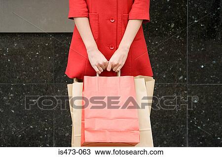 Woman holding shopping bag View Large Photo Image Stock Image - Woman holding shopping bag. Fotosearch