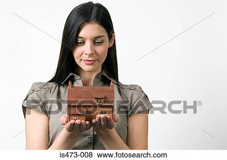 Woman looking at model of house View Large Photo Image Stock Photo - Woman looking at model of house. Fotosearch