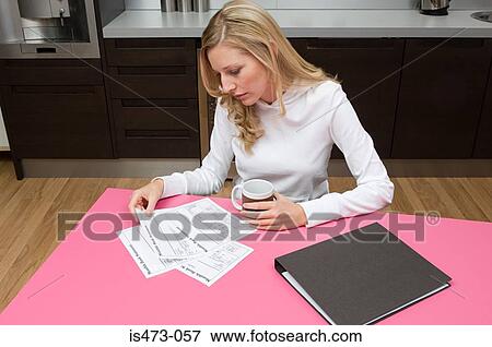 Woman reading bank statements View Large Photo Image Stock Photo - Woman reading bank statements. Fotosearch