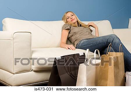 Woman reclining on sofa View Large Photo Image Stock Image - Woman reclining on sofa. Fotosearch
