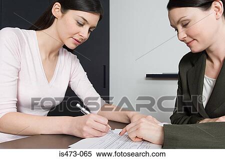 Stock Photography - Woman signing document. Fotosearch